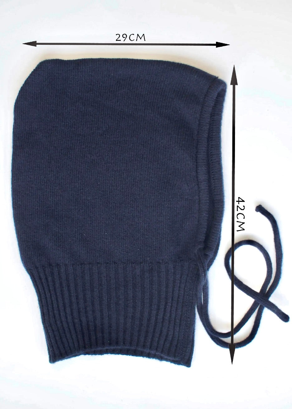 A flat lay of our cashmere knitted balaclava in navy with a white background displaying measurements of the hood 29cm wide by 42cm long