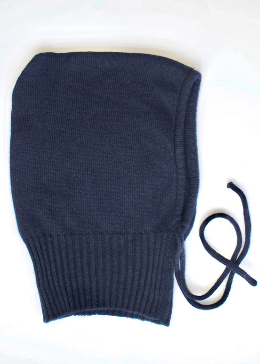 A flay lay of our cashmere knitted balaclava hood in navy with a white background 