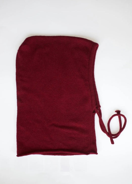 A flat lay of our cashmere knitted balaclava hood in burgundy with a white background displaying the measurements of 42cm wide by 29cm 