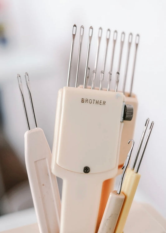 Brother sewing needle case with various needles on a blurred background