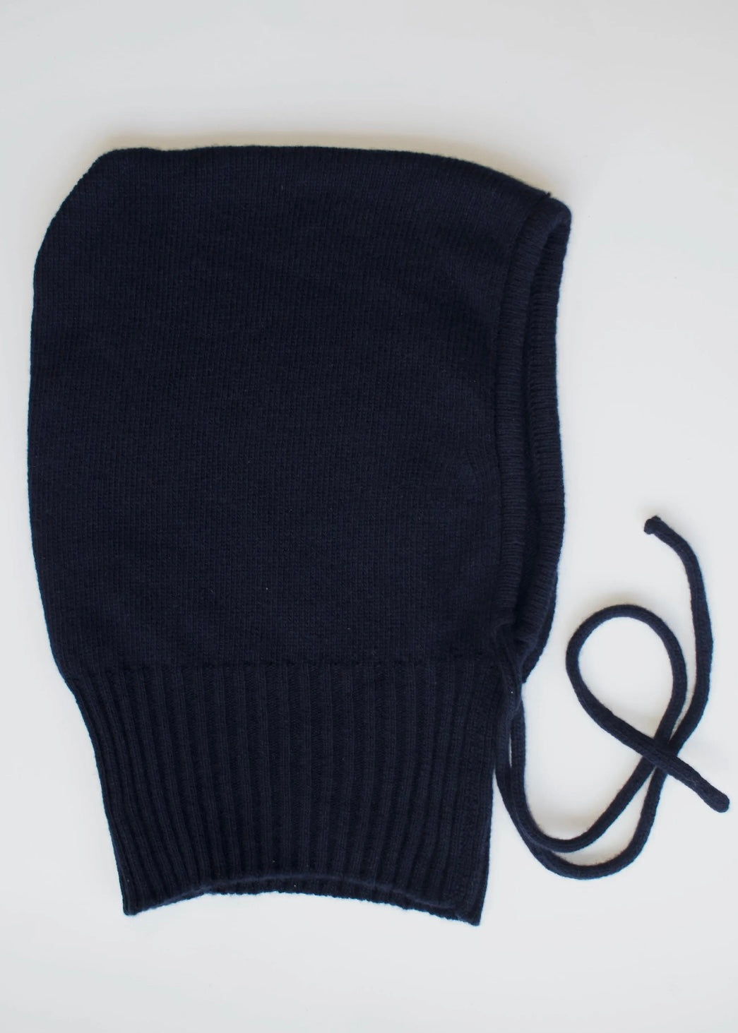 A flat lay of our cashmere knitted black balaclava hood with a white background 