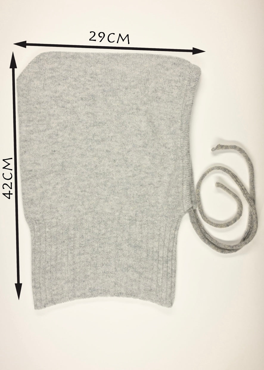 A flay lay of our cashmere knitted balaclava hood in grey with a white background showing the measurements of 29cm wide by 42cm long