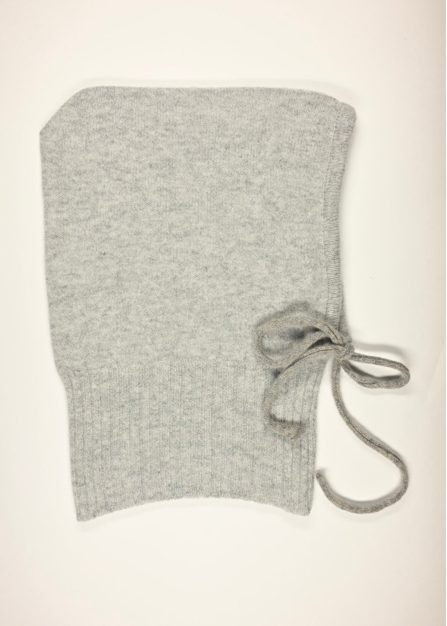 A flay lay of our cashmere knitted balaclava hood in grey with a white background 