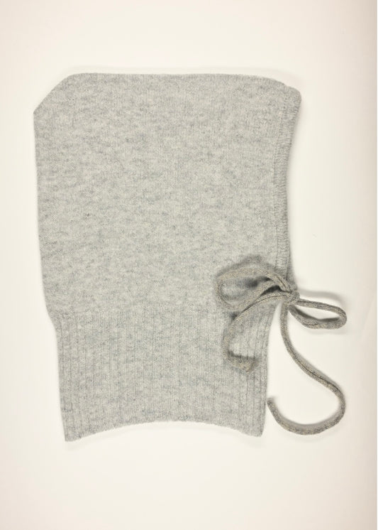 A flay lay of our cashmere knitted balaclava hood in grey with a white background 