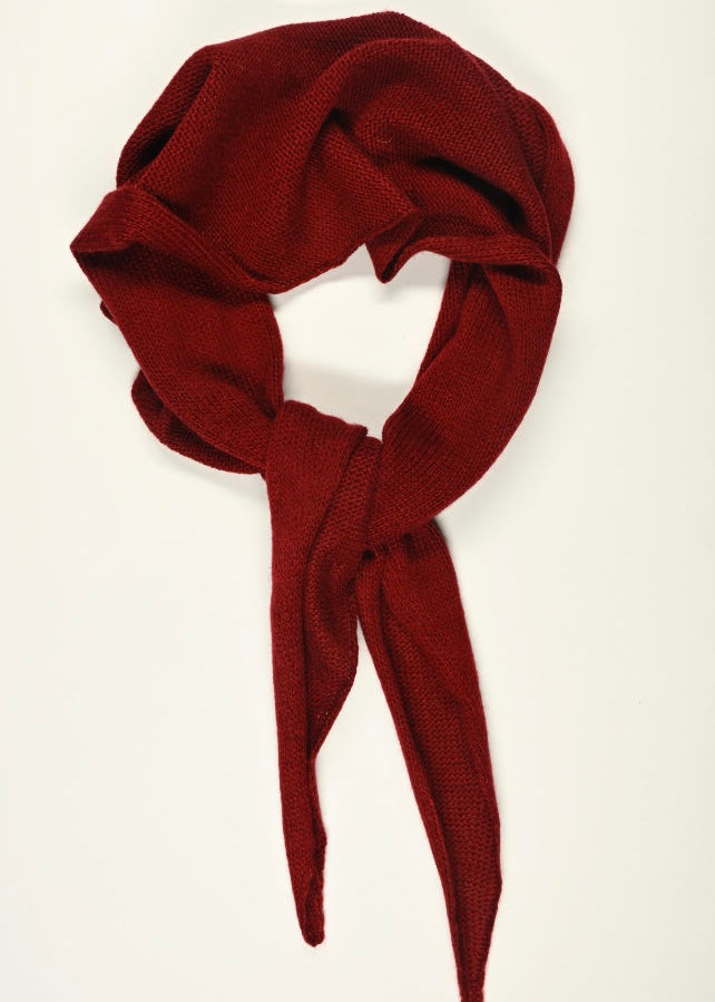 Red scarf tied in a knot on a white background