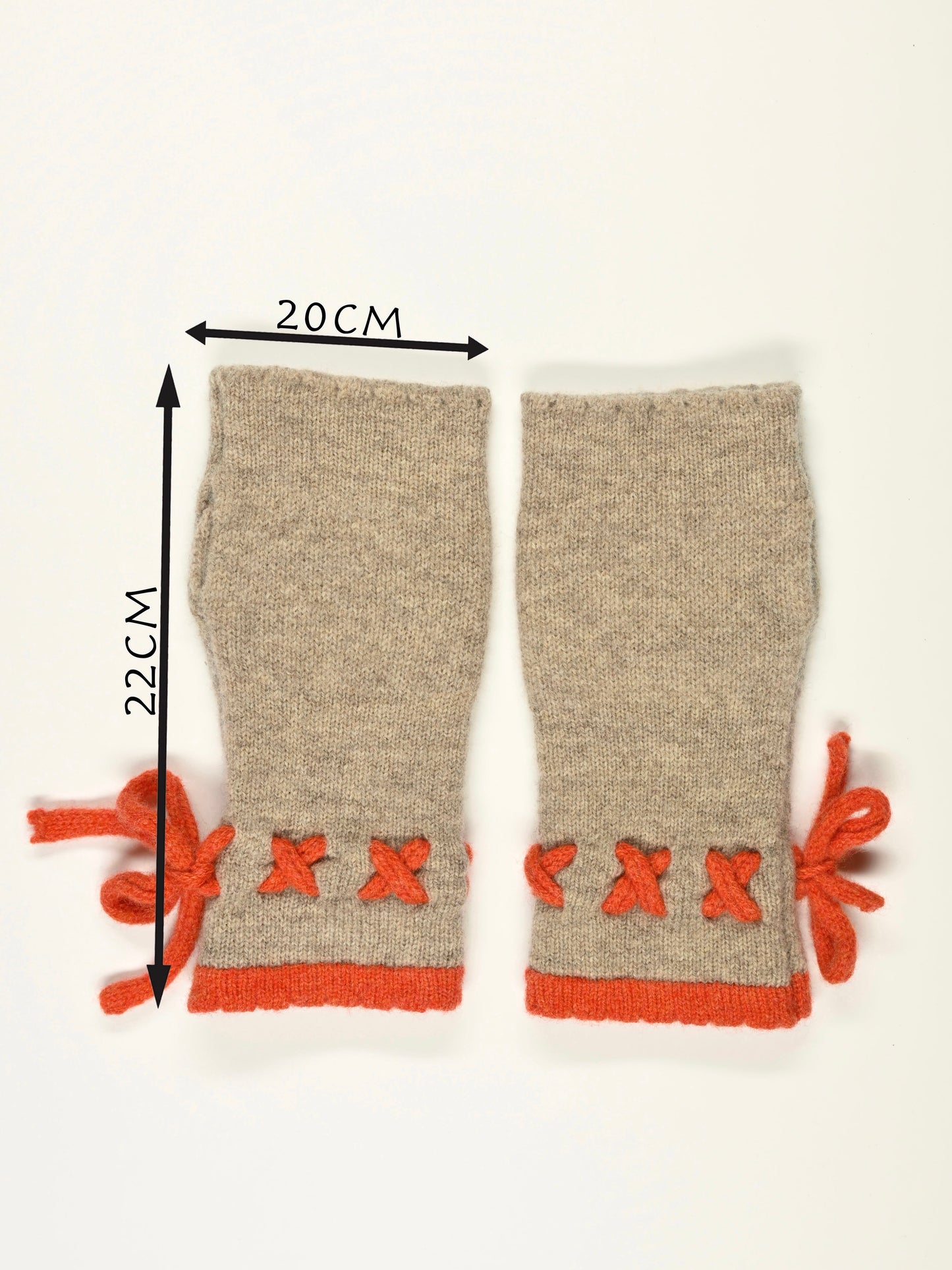 Pair of beige arm warmers with orange decorative elements and measurements (22cm long by 20cm wide) on a white background