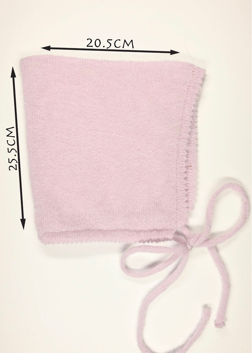 Lilac soft brushed knitted bonnet with measurements (20.5cm wide by 25.5cm long) on a white background