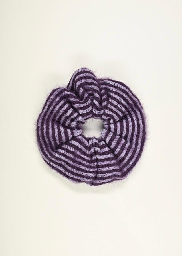 Purple and pink striped knitted scrunchie on a white background