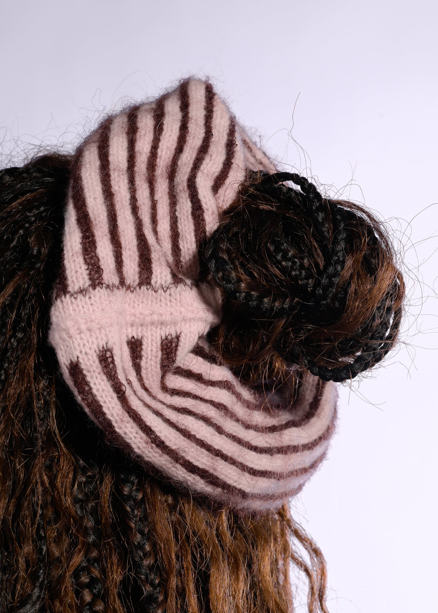 Striped scrunchie on a bun with a white background