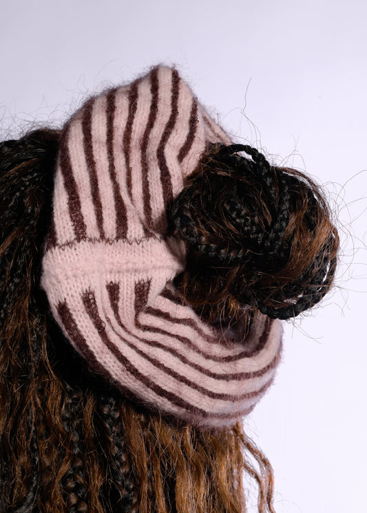 Striped scrunchie on a bun with a white background