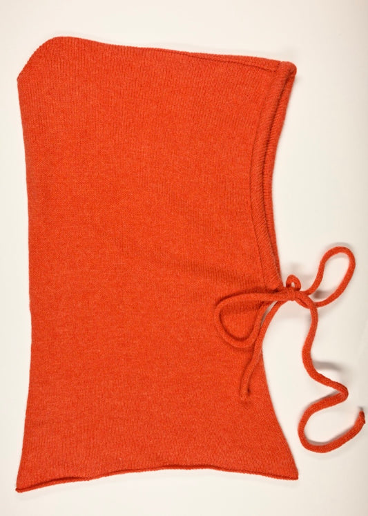 A flat lay of our cashmere knitted balaclava hood in orange with a white background 